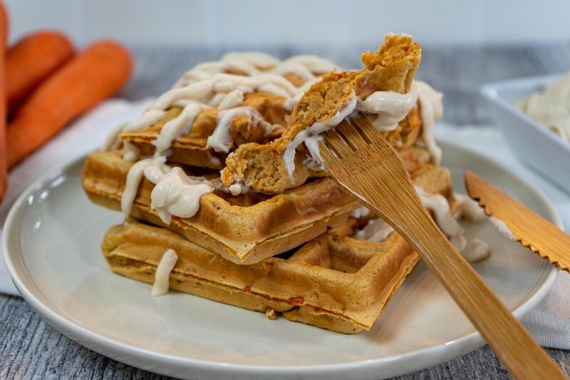 Homemade Vegan Carrot Cake Waffles Drizzled with Non-Dairy Maple Cream Cheese on Plate with Bamboo Fork | Vitacost.com/Blog