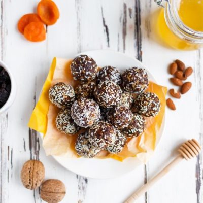 Cacao & Sesame No Bake Energy Balls on Plate Next to Honey, Almonds & Walnuts | Vitacost.com/blog