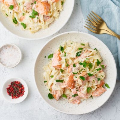Dairy-Free Creamy Salmon Pasta on White Plate with Blue Napkin | Vitacost.com/blog
