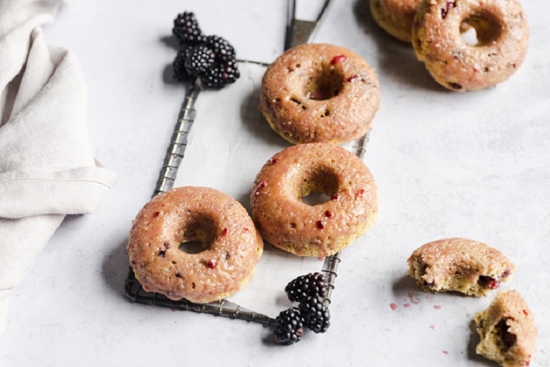 Homemade Gluten-Free Glazed Blackberry Donuts on Cooling Rack with Fresh Blackberries | Vitacost.com/Blog