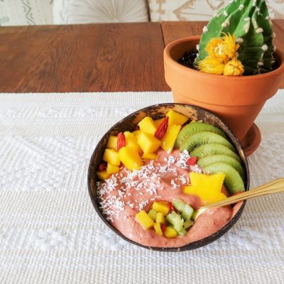 Homemade Hibiscus-Mango Smoothie Bowl topped with Tropical Fruit in Coconut Bowl | Vitacost.com/Blog