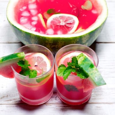 Watermelon Lemonade in Glasses in Front of Watermelon Used as Punch Bowl | Vitacost.com/blog