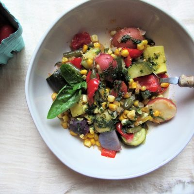 Bowl of Vegetable Stew with Colored Potatoes, Corn, Cherry Tomatoes, Herb Puree and More to Represent Vegetable Stew Recipe | Vitacost.com/Blog