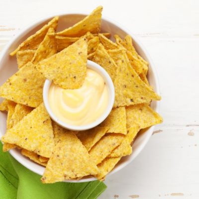Easy Vegan Nacho Cheese Sauce in White Bowl with Tortilla Chips and Green Napkin | Vitacost.com/blog