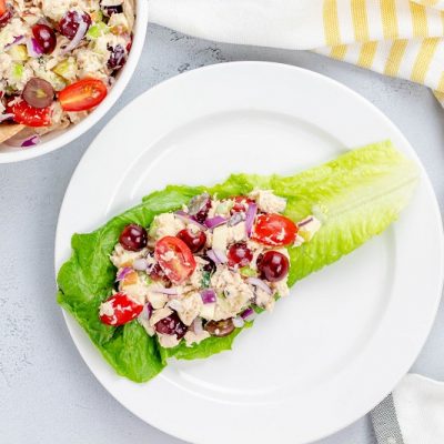 A Portion of Tuna Salad Atop a Romaine Lettuce Leaf on a White Plate Next to a Bowl of Tuna Salad to Represent Tuna Salad Recipe | Vitacost.com/Blog