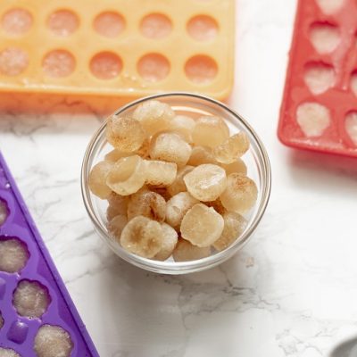 A Small Glass Bowl of Light Brown Gummies is Surrounded by Colorful Silicone Gummy Molds to Represent an Apple Cider Vinegar Gummies Recipe | Vitacost.com/Blog