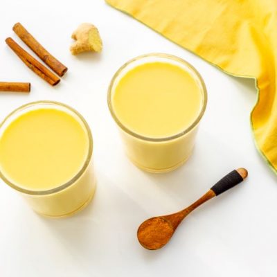 Iced Golden Milk Latte in Two Glasses on White Table | Vitacost.com/blog