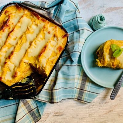 Plantain Lasagna Pastelón in Casserole Dish with Serving on Blue Plate | Vitacost.com/blog
