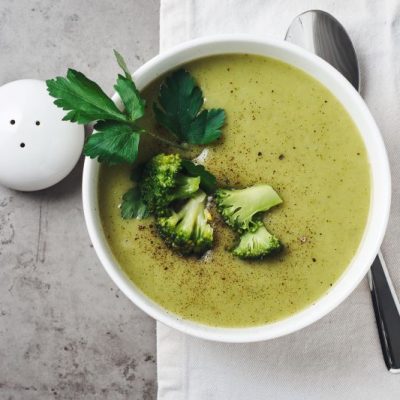 Creamy Vegan Broccoli Cheese Soup in White Bowl with Florets on Top | Vitacost.com/blog