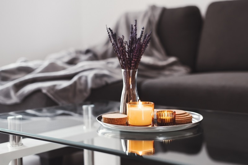 Benefits of CBD Candles Lit CBD Candle on Coffee Table | Vitacost.com/Blog