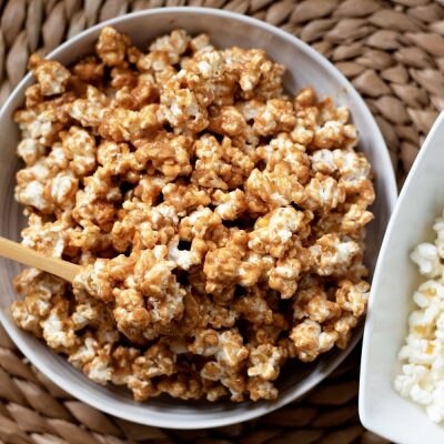 A Small Bowl of Peanut Butter Popcorn Sits on a Wicker Table to Represent a Peanut Butter Popcorn Recipe | Vitacost.com/Blog