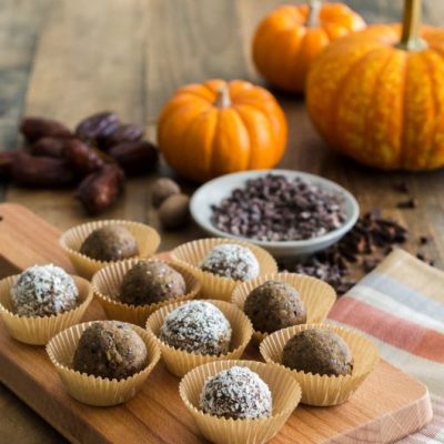 Pumpkin Spice Protein Bites on Wooden Board on Table with Dates, Pumpkins & Cacao Nibs | Vitacost.com/blog