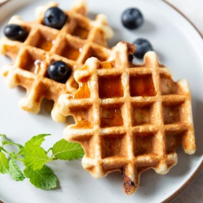 Vanilla Collagen Protein Waffles on White Plate with Berries and Maple Syrup | Vitacost.com/blog