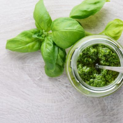 Pumpkin Seed Pesto in Glass Jar Next to Basil Leaves on Countertop | Vitacost.com/blog
