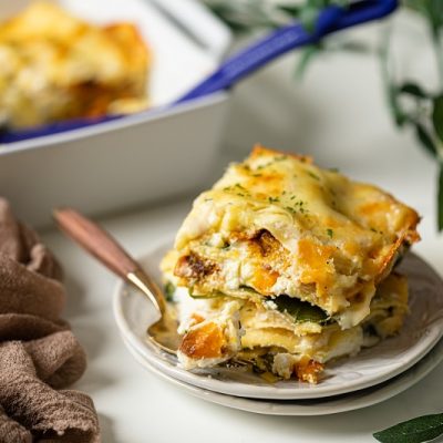 A Slice of Homemade Meatless Butternut Squash Lasagna on Plate Next to Casserole Dish | Vitacost.com/Blog