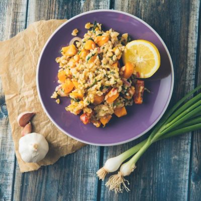 Grain-Free Butternut Squash Risotto on Purple Plate Set on Wooden Table | Vitacost.com/blog