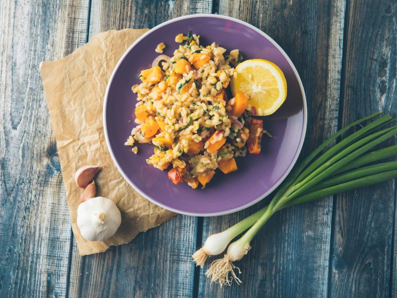 Grain-Free Butternut Squash Risotto on Purple Plate Set on Wooden Table | Vitacost.com/blog
