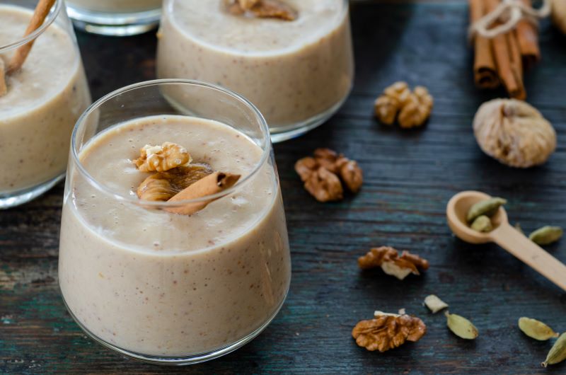 Coconut Milk Pudding With Fig in Glasses on Blue Wood Table with Walnuts & Cinnamon | Vitacost.com/blog