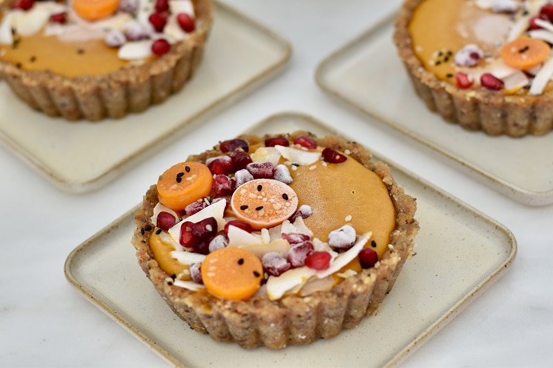 Three Small Pumpkin Mousse Tarts Topped With Pomegranate Seeds, Shredded Coconut and Sliced Fruit | Vitacost.com/Blog
