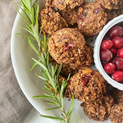 A Close-Up View of Tempeh Meatballs With a Sprig of Rosemary and a Bowl of Cranberries | Vitacost.com/Blog