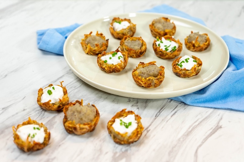 A Plate of Vegan Potato Latkes Shaped into Cups Filled With Applesauce and Sour Cream | Vitacost.com/Blog