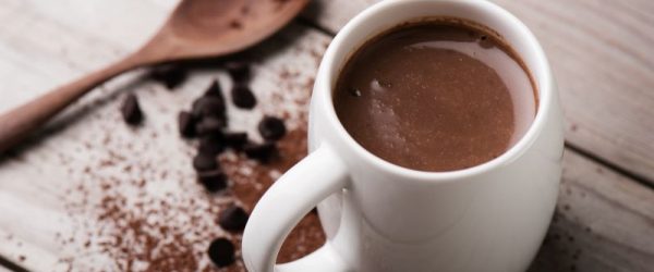 Creamy Keto Cocoa_Lizzy Briskin Creamy Keto Hot Chocolate in Mug on Wooden Tabletop | Vitacost.com/blog