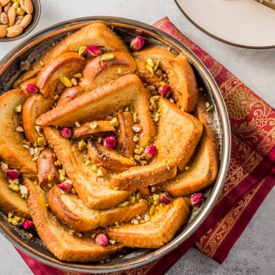 Homemade Bread Pudding in Skillet Garnished with Edible Flowers and Nuts | Vitacost.com/Blog