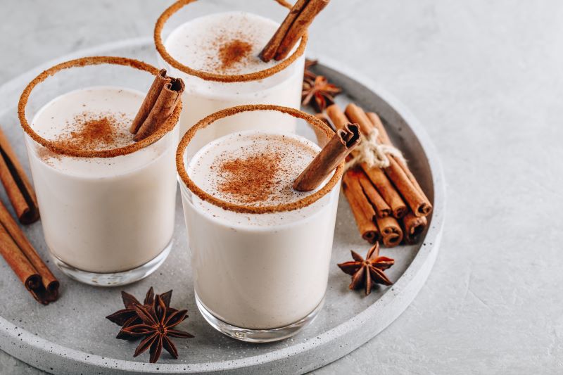 Coconut Milk Dairy Free Eggnog in Glasses with Cinnamon Sticks on Serving Tray | Vitacost.com/blog