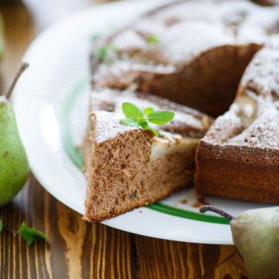 Spiced Pear Cake on Serving Plate with Whole Pears on Wood Tabletop | Vitacost.com/blog