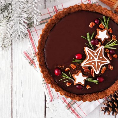 Vegan Chocolate Gingerbread Tart With Holiday Decorations on White Wood Table | Vitacost.com/blog