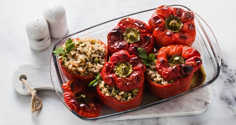 Vegetarian Stuffed Peppers in a Glass Dish on a Marble Table | Vitacost.com/Blog