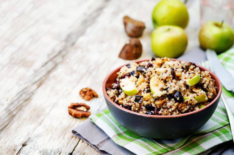 Apple Walnut Quinoa Salad With Spinach & Cranberries in Bowl on Wood Table | Vitacost.com/blog