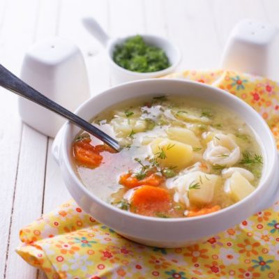 Chicken Bone Broth Cleansing Detox Soup in Bowl on Flowery Cloth Napkin | Vitacost.com/blog