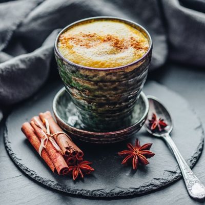 Homemade Foamy Collagen Chai Latte Dusted with Cinnamon in Mug on Saucer | Vitacost.com/Blog