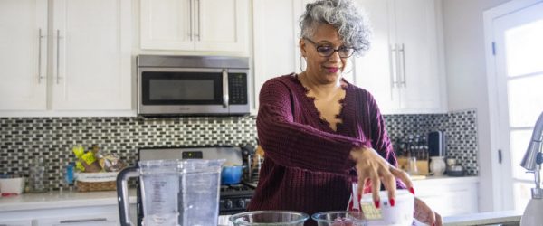 Concept of What is the DASH Diet Represented by Woman Making Smoothie in Kitchen | Vitacost.com/blog