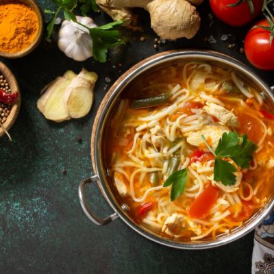 Chicken Ramen With Ginger, Garlic & Spices in Pot on Counter with Fresh Herbs & Spices | Vitacost.com/blog