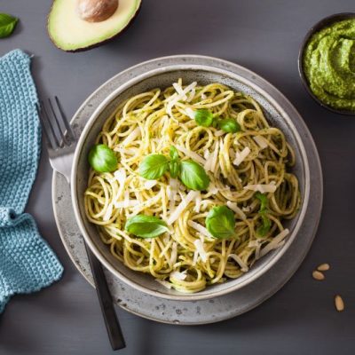 Creamy Avocado Pesto Pasta in Stoneware Bowl With Side Bowls of Pesto & Cheese | Vitacost.com/blog