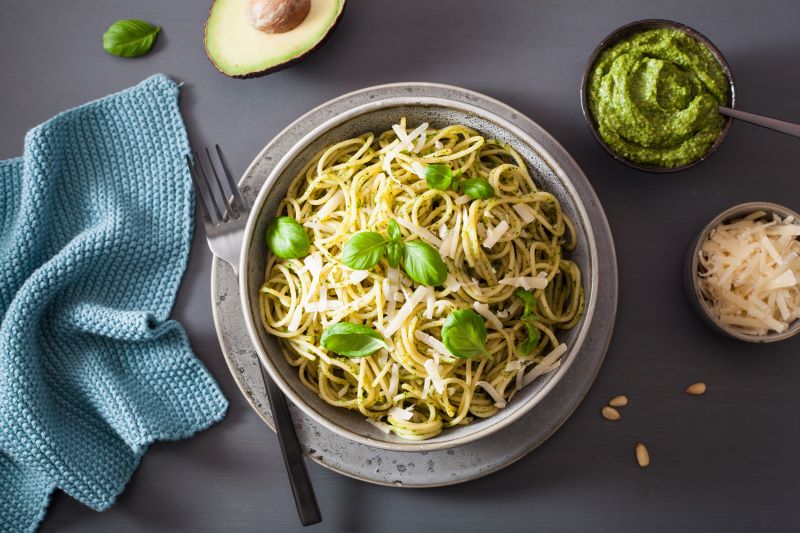 Creamy Avocado Pesto Pasta in Stoneware Bowl With Side Bowls of Pesto & Cheese | Vitacost.com/blog
