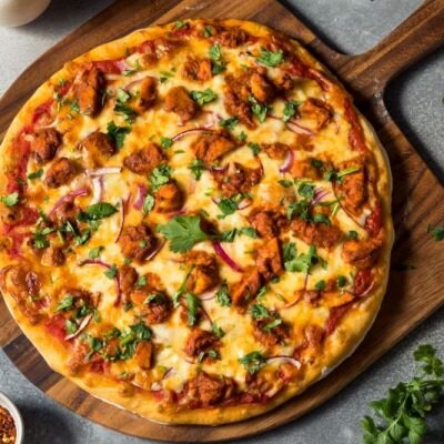 Thai Chicken Pizza on Wood Cutting Board on Gray Slate Counter | Vitacost.com/blog