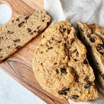Homemade Vegan Irish Soda Bread with Caraway Seeds and Raisins on Wooden Cutting Board | Vitacost.com/Blog