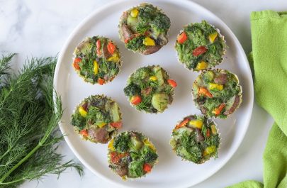Eight Mini Frittata Muffins Sit On a White Plate Next to a Bunch of Fresh Dill | Vitacost.com/Blog
