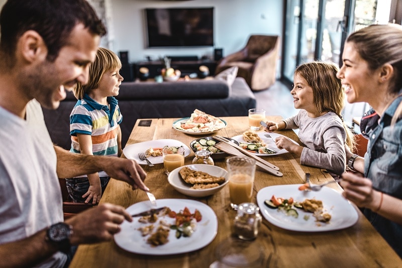 A Young Family Enjoys a Meal Together to Represent Family Meals | Vitacost.com/Blog