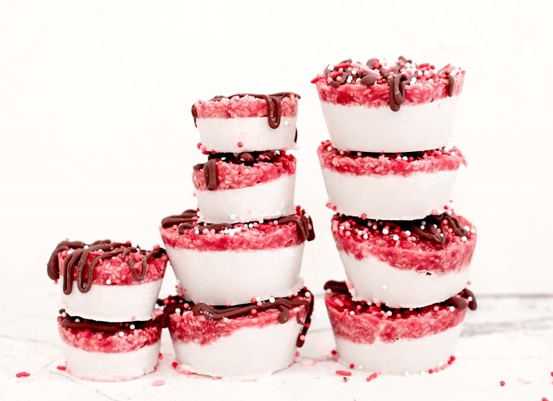 A Stack of Coconut Raspberry Bars With Chocolate Drizzle and Red and White Sprinkles | Vitacost.com/Blog
