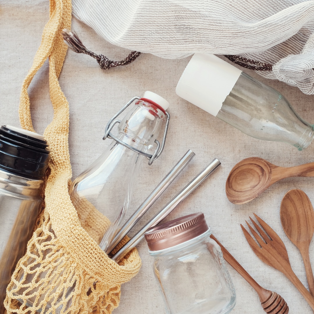 Reusable Mesh Cotton Bag Filled with Glass Bottle, Stainless Steel Straws, Bamboo Cutlery and More | Vitacost.com/Blog