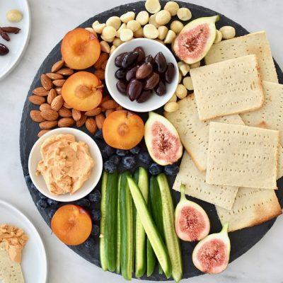 A Round Platter With Gluten Free Matzo, Quartered Cucumbers, Figs, Apricots, Nuts and Spreads | Vitacost.com/Blog