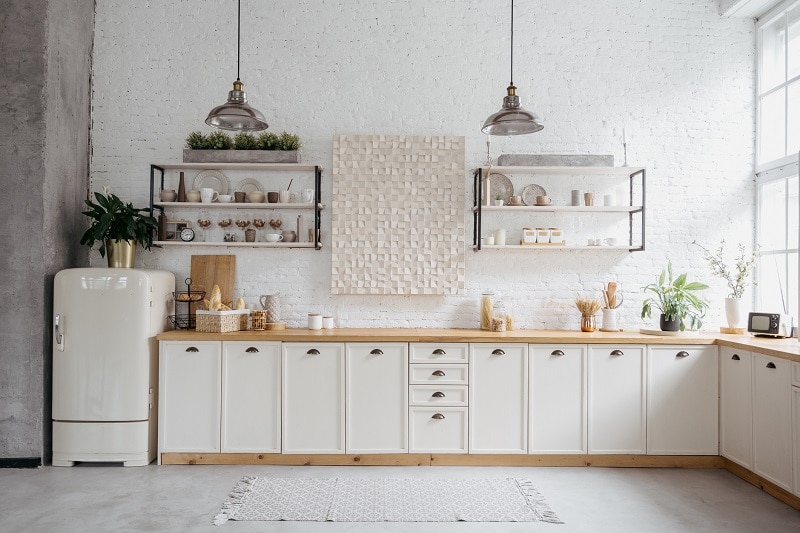 A White, Airy, Minimalist, Clutter-Free Kitchen With Large Windows and Light Wood Countertop Represents a Zen Kitchen | Vitacost.com/Blog