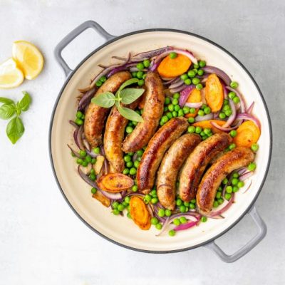 Baked sausage & veggies in one cast iron pan on marble counter | Vitacost.com/blog