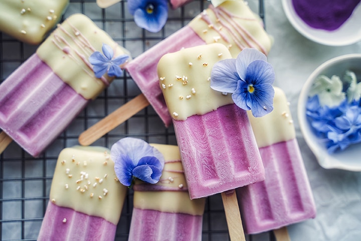 Plant-Based Sweet Potato "Cheescake" Ice Cream Pops Dipped in White Chocolate and Garnished with Edible Flowers on Wire Rack | Vitacost.com/Blog