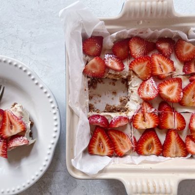 Homemade No-Bake Vegan Strawberry Cheesecake Bars Topped with Fresh Strawberries in White Dish | Vitacost.com/Blog