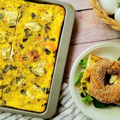 Sheet Pan Eggs Sit Beside a Small Plate With a Sesame Bagel | Vitacost.com/Blog